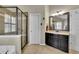 Elegant bathroom featuring a glass shower enclosure and stylish vanity with dark wood cabinetry at 202 Roseman Way, Woodstock, GA 30188