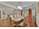 Sophisticated dining room with a large table, stylish chairs, hardwood flooring, and ample natural light at 202 Roseman Way, Woodstock, GA 30188