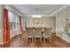 Elegant dining room featuring a modern chandelier, large windows, and hardwood floors at 202 Roseman Way, Woodstock, GA 30188