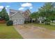 Charming two-story home featuring a brick facade, well-manicured lawn, and a two-car garage at 202 Roseman Way, Woodstock, GA 30188