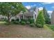 Attractive two-story home with a manicured lawn, mature trees, and inviting front porch at 202 Roseman Way, Woodstock, GA 30188