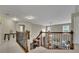 Upper hallway featuring carpet floors, a wooden railing, and a view of the living room below at 202 Roseman Way, Woodstock, GA 30188