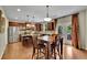 Well-equipped kitchen with stainless steel appliances, an island, and a dining table with natural light from a patio door at 202 Roseman Way, Woodstock, GA 30188