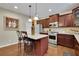 Modern kitchen featuring stainless steel appliances, granite countertops, a center island, and dark wood cabinets at 202 Roseman Way, Woodstock, GA 30188