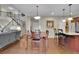 Inviting kitchen and dining area with stainless steel appliances, an island with barstools, and hardwood flooring at 202 Roseman Way, Woodstock, GA 30188