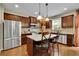Gourmet kitchen with granite countertops, cherry cabinets, a center island, and modern stainless steel appliances at 202 Roseman Way, Woodstock, GA 30188