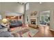 Spacious living room with a fireplace, high ceilings, hardwood floors, and an open layout at 202 Roseman Way, Woodstock, GA 30188