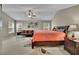 Spacious main bedroom with a seating area, large windows, ceiling fan, and comfortable furnishings at 202 Roseman Way, Woodstock, GA 30188
