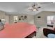 Spacious main bedroom with seating area, ceiling fan, ensuite bathroom, and comfortable furnishings at 202 Roseman Way, Woodstock, GA 30188