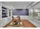 Bright home office featuring built-in shelving, hardwood floors, and a comfortable workspace at 202 Roseman Way, Woodstock, GA 30188