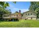 View of the backyard featuring a deck and mature trees, perfect for outdoor enjoyment at 2067 Skyhawk Ln, Acworth, GA 30102