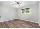 This bedroom features wood flooring, a ceiling fan, and a window for natural light at 2067 Skyhawk Ln, Acworth, GA 30102