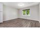 Bright bedroom featuring modern light fixture, fresh paint, new flooring and natural light at 2067 Skyhawk Ln, Acworth, GA 30102