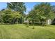 Charming home featuring a well-maintained lawn, mature trees, and a classic exterior at 2067 Skyhawk Ln, Acworth, GA 30102