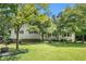 Charming home featuring a well-maintained lawn, mature trees, and a classic exterior at 2067 Skyhawk Ln, Acworth, GA 30102