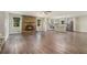 Spacious living room featuring wood floors, a stone fireplace, and an open layout to the kitchen at 2067 Skyhawk Ln, Acworth, GA 30102