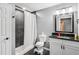 Cozy bathroom with tiled shower, vanity with dark countertop, and modern fixtures at 2118 Braswell Ln, Loganville, GA 30052