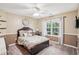 Inviting bedroom featuring neutral tones, a ceiling fan, a cozy bed, and a bright window view at 2118 Braswell Ln, Loganville, GA 30052