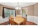 Traditional dining room featuring wood floors, a large window, and a classic chandelier at 2118 Braswell Ln, Loganville, GA 30052