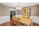 Traditional dining room featuring a wooden table, hutch, chandelier, and view into kitchen at 2118 Braswell Ln, Loganville, GA 30052