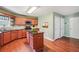 Bright kitchen featuring wood floors, center island, cabinets, and stone tile backsplash at 2118 Braswell Ln, Loganville, GA 30052