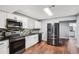Modern kitchen featuring stainless steel appliances, granite countertops, and ample cabinet space at 2118 Braswell Ln, Loganville, GA 30052