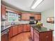 Charming kitchen featuring wood floors, center island, cabinets, and stone tile backsplash at 2118 Braswell Ln, Loganville, GA 30052