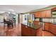 Spacious kitchen boasts wood floors, center island, stainless steel appliances, and breakfast area at 2118 Braswell Ln, Loganville, GA 30052