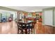 Open concept kitchen features stainless steel appliances, island, and a wooden dining table at 2118 Braswell Ln, Loganville, GA 30052