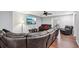 Cozy living room featuring hardwood floors, ceiling fan, and a large comfortable sectional at 2118 Braswell Ln, Loganville, GA 30052