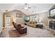 Cozy living room with vaulted ceilings, a stone fireplace, and comfortable seating at 2118 Braswell Ln, Loganville, GA 30052