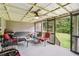 Cozy screened patio overlooking a lush backyard, perfect for outdoor relaxation and entertaining at 2118 Braswell Ln, Loganville, GA 30052