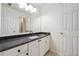 Bathroom with black granite countertop, white cabinets, and updated fixtures at 2335 Corbett Ct, Powder Springs, GA 30127