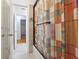 Bathroom showing glass shower doors and view into hall at 2335 Corbett Ct, Powder Springs, GA 30127