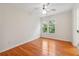 Bright, empty bedroom with hardwood floors, ceiling fan and window overlooking trees at 2335 Corbett Ct, Powder Springs, GA 30127