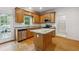 Well-lit kitchen features granite countertops, stainless appliances, and an island at 2335 Corbett Ct, Powder Springs, GA 30127