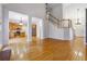 Open-concept living space featuring hardwood floors, staircase, and open kitchen with stainless appliances at 2335 Corbett Ct, Powder Springs, GA 30127