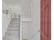 Welcoming foyer with staircase, neutral carpeting, and view to the upper level, exuding charm at 305 Bridgewater Ter, Canton, GA 30115