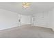 Open living room featuring plush carpeting and modern light fixtures at 305 Bridgewater Ter, Canton, GA 30115