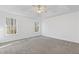 The spacious main bedroom features plush gray carpet flooring and dual windows with wooded views at 305 Bridgewater Ter, Canton, GA 30115