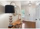 Inviting foyer with stylish table, decorative mirrors, modern lighting, and wood flooring at 2377 Heritage Park Nw Cir # 16, Kennesaw, GA 30144
