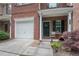 Charming porch featuring a front door with a wreath, seating, and beautiful landscaping at 2377 Heritage Park Nw Cir # 16, Kennesaw, GA 30144