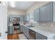 Well-lit kitchen features stainless steel appliances, light-grey cabinets, tile backsplash, and wood flooring at 2377 Heritage Park Nw Cir # 16, Kennesaw, GA 30144