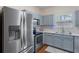 Bright kitchen with stainless steel refrigerator, range, microwave, and dishwasher, plus light-grey cabinets at 2377 Heritage Park Nw Cir # 16, Kennesaw, GA 30144