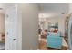 Comfortable living room with wood floors, turquoise seating, modern chandelier, and decorative pillows at 2377 Heritage Park Nw Cir # 16, Kennesaw, GA 30144