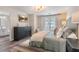 Cozy main bedroom with a large bed, dark dresser, television, and lots of natural light at 2377 Heritage Park Nw Cir # 16, Kennesaw, GA 30144
