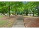 A winding sidewalk leads to a charming playground surrounded by lush greenery and mature trees at 2377 Heritage Park Nw Cir # 16, Kennesaw, GA 30144