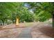 Community playground with slide and swing set amidst mature trees, perfect for outdoor fun at 2377 Heritage Park Nw Cir # 16, Kennesaw, GA 30144