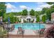 Community pool area featuring a fenced pool with chairs and tables surrounding it at 2377 Heritage Park Nw Cir # 16, Kennesaw, GA 30144