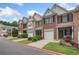 A street view showcasing townhomes, well-maintained lawns, and paved walkways in a residential neighborhood at 2377 Heritage Park Nw Cir # 16, Kennesaw, GA 30144